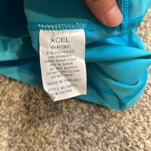 Xcel/ UV protection teal short sleeved swim shirt with one small pocket‌ - Picture 2 of 6